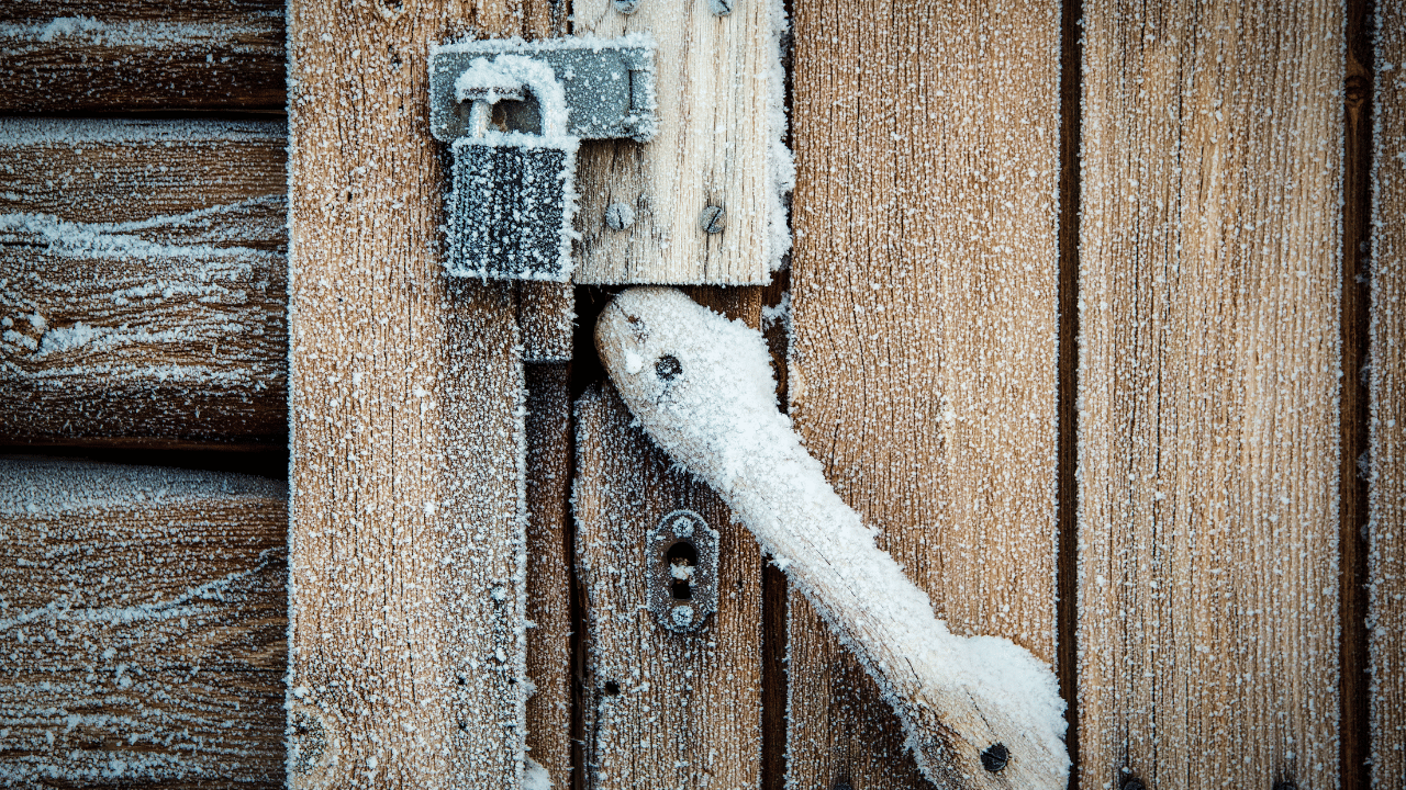 How do you unfreeze a frozen house door lock?